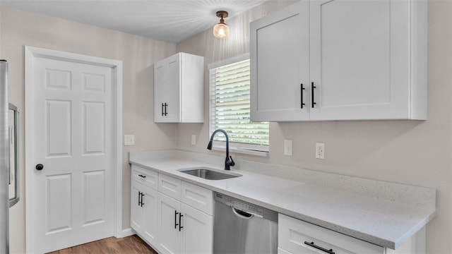 3829 Abbott Ln, Lakeland, FL 33810 - kitchen featuring stainless steel dishwasher, a sink, and white cabinetry