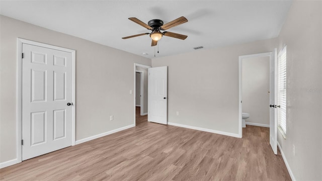3829 Abbott Ln, Lakeland, FL 33810 - unfurnished bedroom with light wood-style floors, connected bathroom, baseboards, and ceiling fan