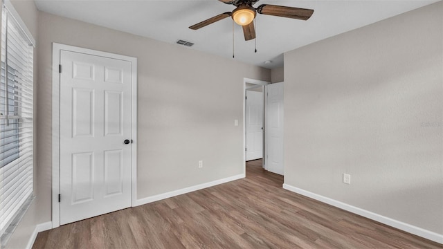 3829 Abbott Ln, Lakeland, FL 33810 - unfurnished bedroom with baseboards, wood finished floors, and a ceiling fan