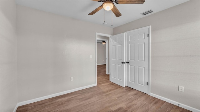 3829 Abbott Ln, Lakeland, FL 33810 - unfurnished bedroom with wood finished floors, baseboards, a closet, and a ceiling fan
