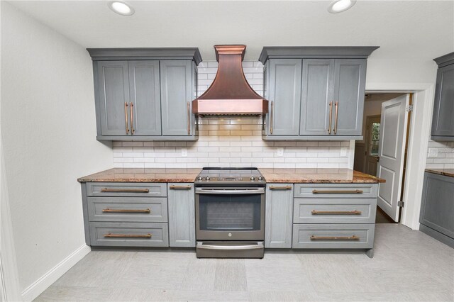 509 Rob Roy St, Lakeland, FL 33813 - kitchen featuring stainless steel electric range, premium range hood, gray cabinets, and tasteful backsplash