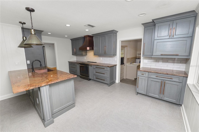 509 Rob Roy St, Lakeland, FL 33813 - kitchen featuring electric stove, premium range hood, gray cabinets, stone countertops, and decorative backsplash