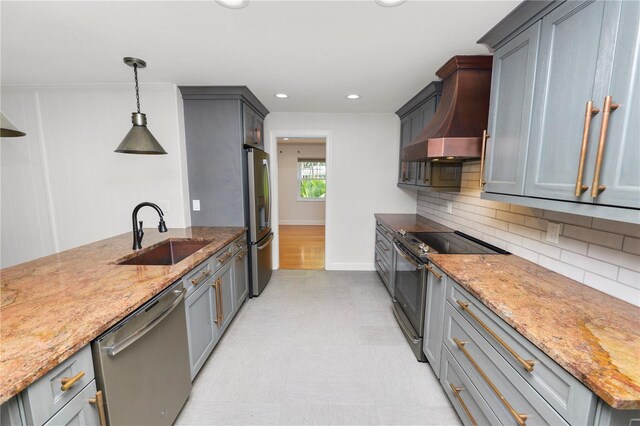 509 Rob Roy St, Lakeland, FL 33813 - kitchen with appliances with stainless steel finishes, a sink, custom range hood, light stone counters, and recessed lighting