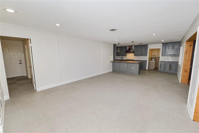 509 Rob Roy St, Lakeland, FL 33813 - unfurnished living room featuring a sink, recessed lighting, and baseboards