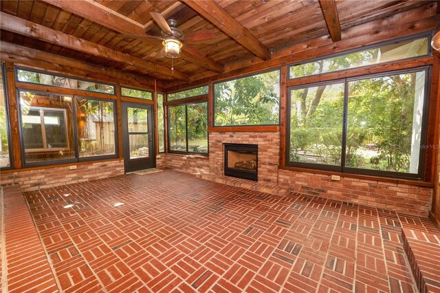 509 Rob Roy St, Lakeland, FL 33813 - unfurnished sunroom with a brick fireplace, ceiling fan, and beam ceiling