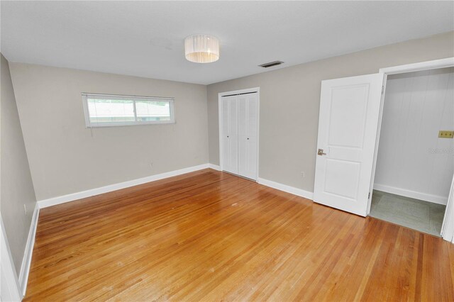 509 Rob Roy St, Lakeland, FL 33813 - unfurnished bedroom with light wood-style floors, baseboards, and a closet