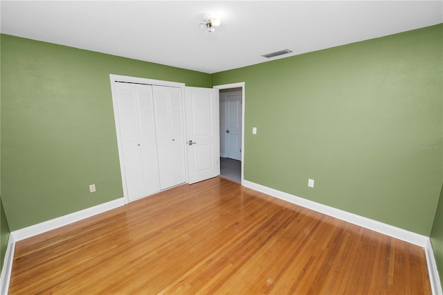 509 Rob Roy St, Lakeland, FL 33813 - unfurnished bedroom with baseboards, a closet, and light wood-style flooring