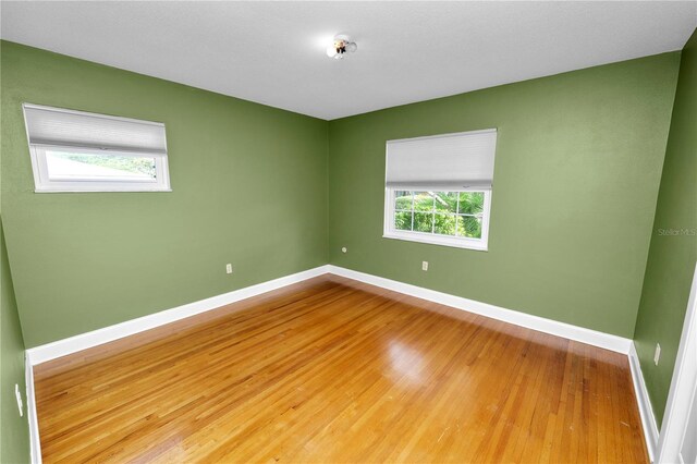 509 Rob Roy St, Lakeland, FL 33813 - unfurnished room featuring baseboards, healthy amount of natural light, and wood finished floors