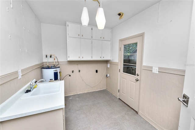 509 Rob Roy St, Lakeland, FL 33813 - laundry room featuring electric water heater, a wainscoted wall, a sink, and light flooring