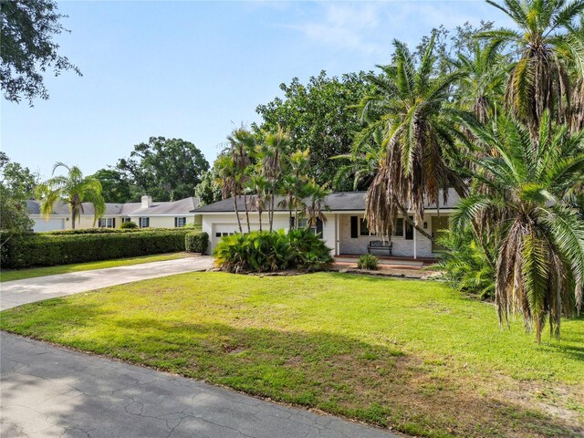 509 Rob Roy St, Lakeland, FL 33813 - single story home featuring concrete driveway, covered porch, a front yard, and an attached garage