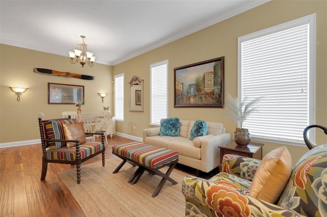 2731 Coventry Ave, Lakeland, FL 33803 - living area featuring a chandelier, light wood finished floors, baseboards, crown molding, and healthy amount of natural light