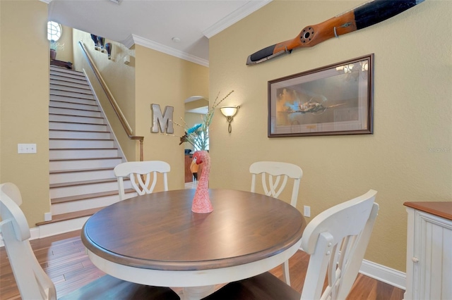2731 Coventry Ave, Lakeland, FL 33803 - dining area with wood finished floors, ornamental molding, stairs, and baseboards
