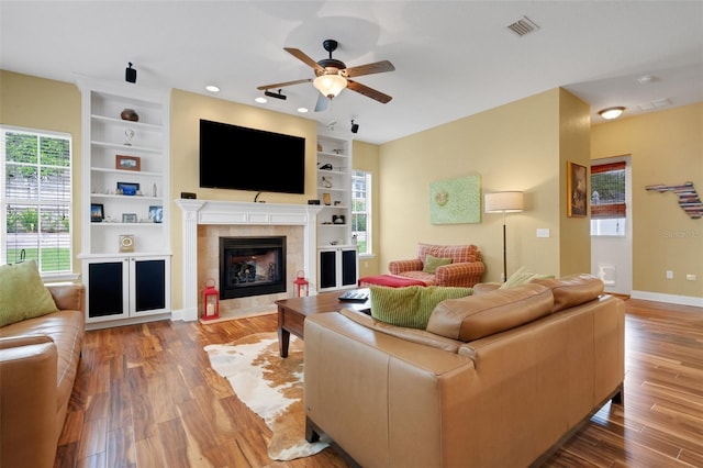 2731 Coventry Ave, Lakeland, FL 33803 - living room featuring ceiling fan, built in shelves, wood finished floors, a tile fireplace, and recessed lighting