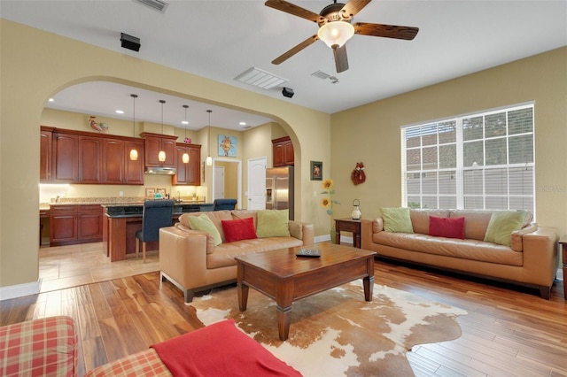 2731 Coventry Ave, Lakeland, FL 33803 - living room with arched walkways, ceiling fan, light wood finished floors, baseboards, and recessed lighting