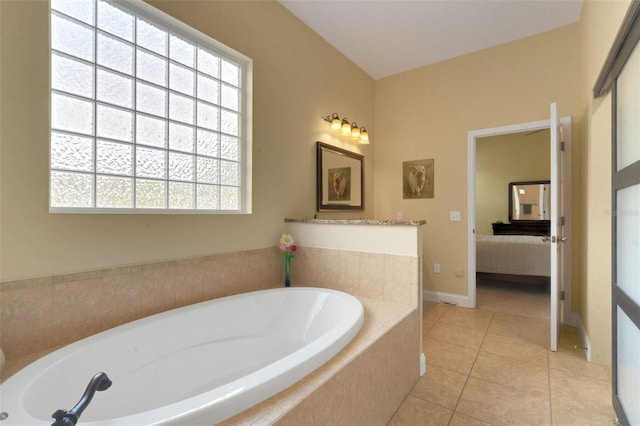 2731 Coventry Ave, Lakeland, FL 33803 - bathroom with a bath, tile patterned floors, connected bathroom, and baseboards