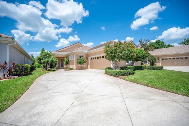 2425 Laurel Glen Dr, Lakeland, FL 33803 - view of front of property featuring a garage, driveway, a front yard, and stucco siding