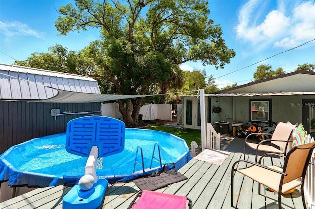 1648 Skinner St, Lakeland, FL 33801 - view of swimming pool featuring french doors and a deck