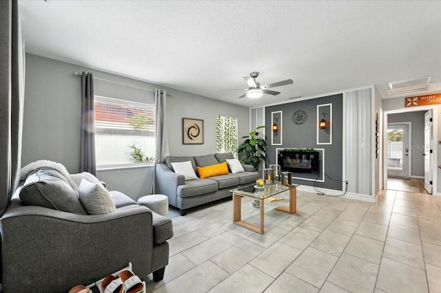 1648 Skinner St, Lakeland, FL 33801 - living room featuring healthy amount of natural light, ceiling fan, light tile patterned floors, and a textured ceiling