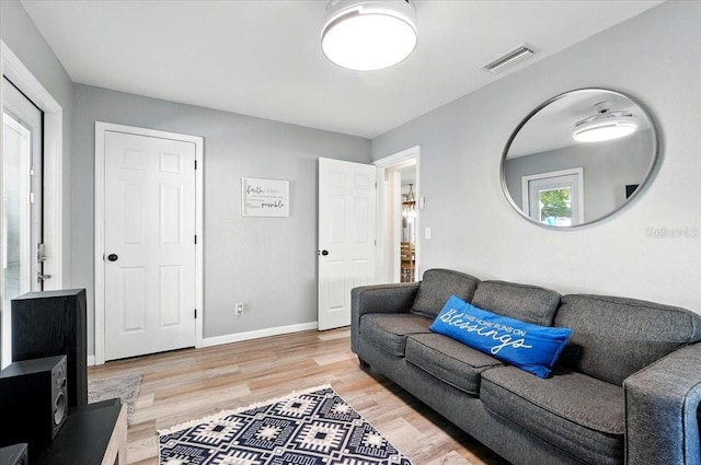 1648 Skinner St, Lakeland, FL 33801 - living room with light wood-style floors and baseboards