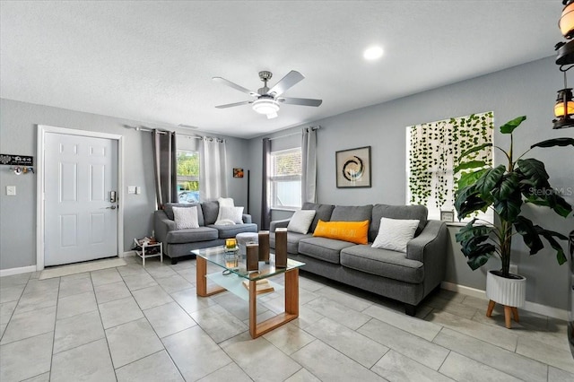 1648 Skinner St, Lakeland, FL 33801 - living area with a ceiling fan, baseboards, and a textured ceiling