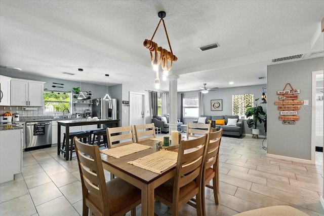 1648 Skinner St, Lakeland, FL 33801 - dining area featuring a textured ceiling, ceiling fan, baseboards, and light tile patterned floors