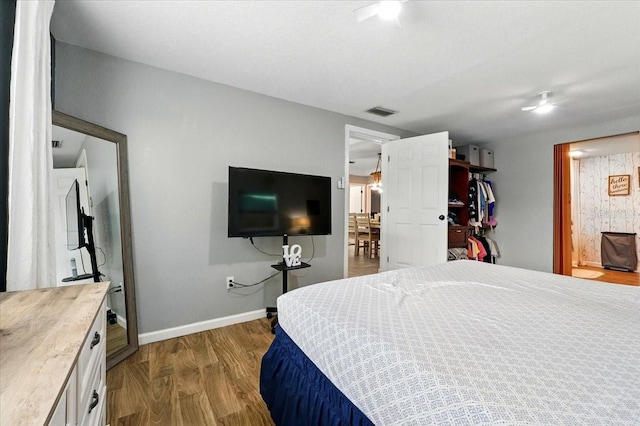 1648 Skinner St, Lakeland, FL 33801 - bedroom with wood finished floors, baseboards, and connected bathroom