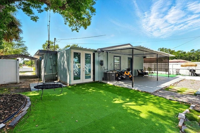 1648 Skinner St, Lakeland, FL 33801 - rear view of house with a patio, stucco siding, and central AC