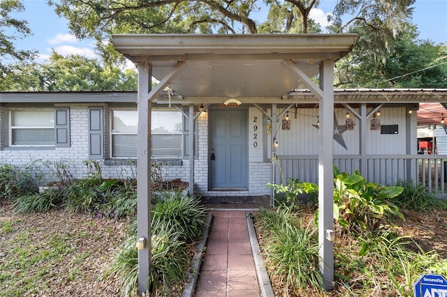 2920 Audie Combee Rd, Lakeland, FL 33801 - view of front of home featuring brick siding and covered porch
