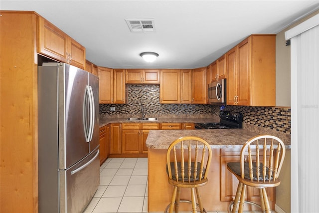 2920 Audie Combee Rd, Lakeland, FL 33801 - kitchen featuring appliances with stainless steel finishes, a sink, tasteful backsplash, and light tile patterned flooring
