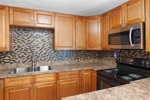 2920 Audie Combee Rd, Lakeland, FL 33801 - kitchen with stainless steel microwave, black electric range, a sink, and light countertops