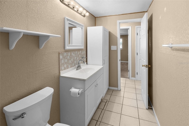 2920 Audie Combee Rd, Lakeland, FL 33801 - half bathroom featuring vanity, toilet, a textured wall, tile patterned flooring, and tasteful backsplash