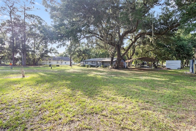 2920 Audie Combee Rd, Lakeland, FL 33801 - view of grassy yard featuring a detached carport