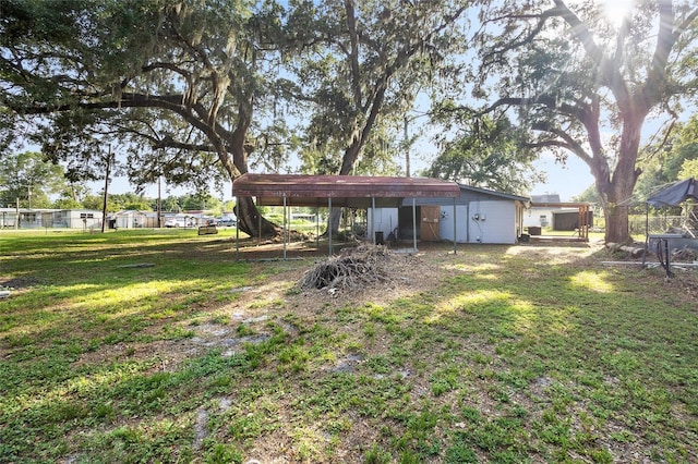 2920 Audie Combee Rd, Lakeland, FL 33801 - view of green lawn with a carport, an outbuilding, and an outdoor structure