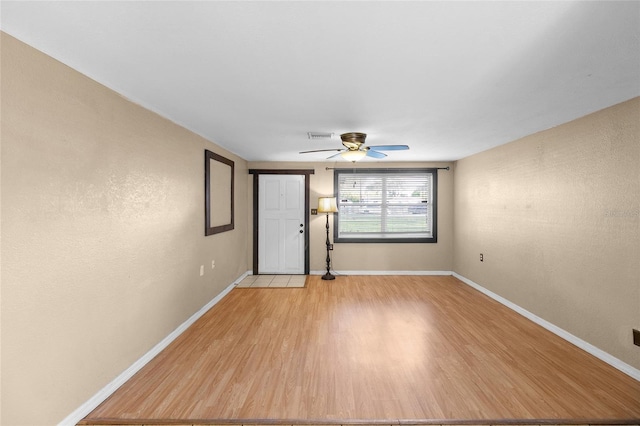 2920 Audie Combee Rd, Lakeland, FL 33801 - entrance foyer with light wood-type flooring, a ceiling fan, and baseboards