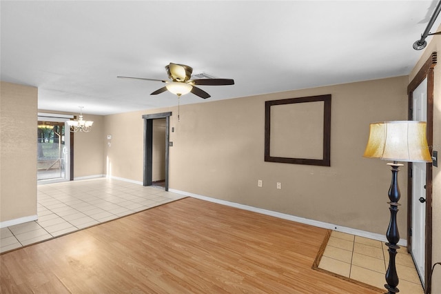 2920 Audie Combee Rd, Lakeland, FL 33801 - tiled spare room featuring ceiling fan, a chandelier, and baseboards
