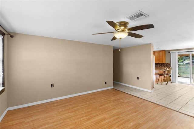 2920 Audie Combee Rd, Lakeland, FL 33801 - empty room with ceiling fan, light wood-type flooring, and baseboards