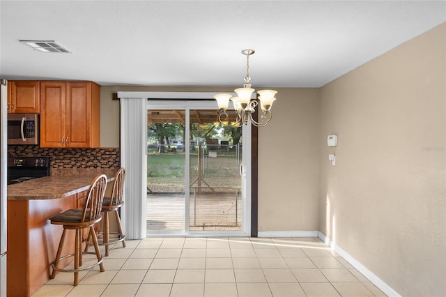 2920 Audie Combee Rd, Lakeland, FL 33801 - dining room with a chandelier and baseboards