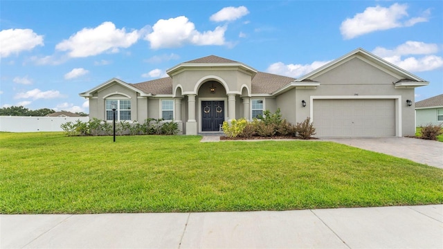 1146 Enclave Ct, Auburndale, FL 33823 - mediterranean / spanish home featuring stucco siding, a garage, and decorative driveway