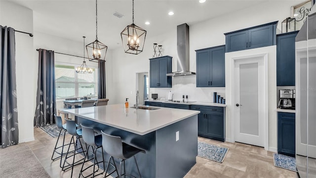 1146 Enclave Ct, Auburndale, FL 33823 - kitchen featuring a sink, wall chimney range hood, a chandelier, black electric cooktop, and a breakfast bar area