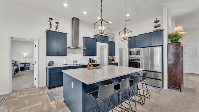 1146 Enclave Ct, Auburndale, FL 33823 - kitchen with appliances with stainless steel finishes, wall chimney exhaust hood, blue cabinets, a sink, and light countertops