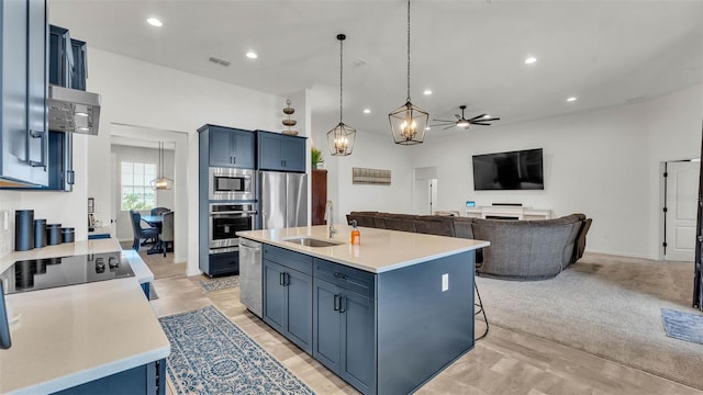 1146 Enclave Ct, Auburndale, FL 33823 - kitchen with stainless steel appliances, a sink, blue cabinets, light countertops, and recessed lighting