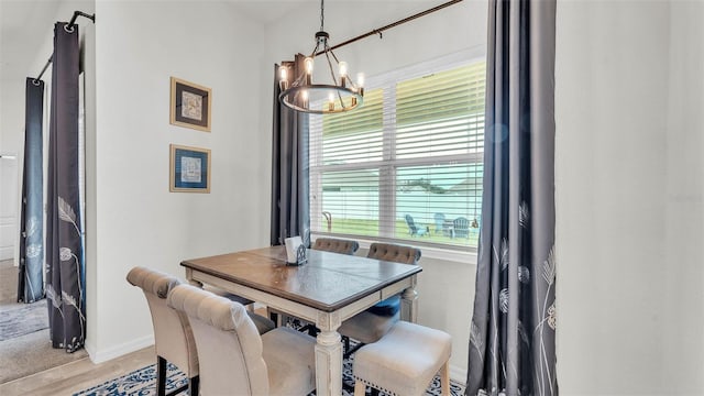 1146 Enclave Ct, Auburndale, FL 33823 - dining room with a chandelier, baseboards, and light wood finished floors