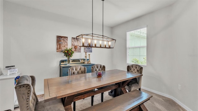 1146 Enclave Ct, Auburndale, FL 33823 - dining area featuring baseboards, light carpet, and a chandelier