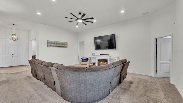 1146 Enclave Ct, Auburndale, FL 33823 - living room with light colored carpet, ceiling fan, a glass covered fireplace, recessed lighting, and baseboards