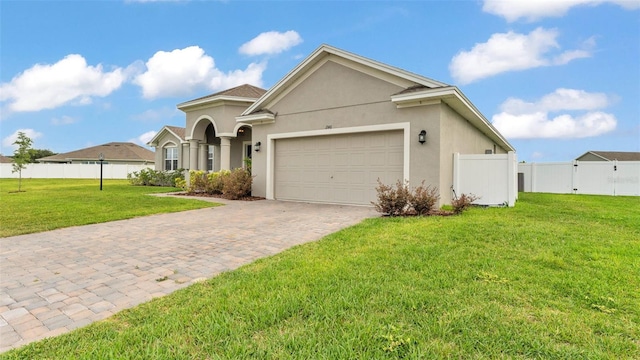 1146 Enclave Ct, Auburndale, FL 33823 - view of front facade featuring an attached garage, decorative driveway, and stucco siding