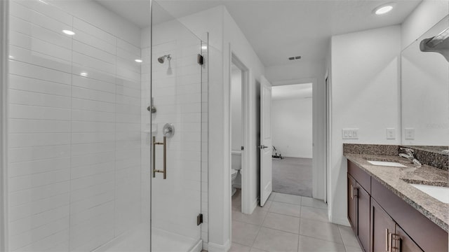 2546 Red Egret Dr, Bartow, FL 33830 - bathroom featuring a stall shower, toilet, tile patterned flooring, and double vanity