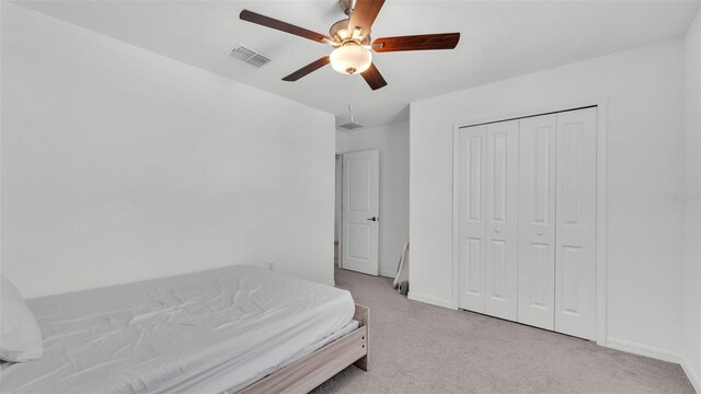 2546 Red Egret Dr, Bartow, FL 33830 - bedroom with light carpet, baseboards, a closet, and a ceiling fan
