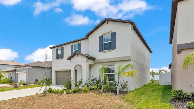 2546 Red Egret Dr, Bartow, FL 33830 - view of front facade with stucco siding, concrete driveway, an attached garage, and a front lawn