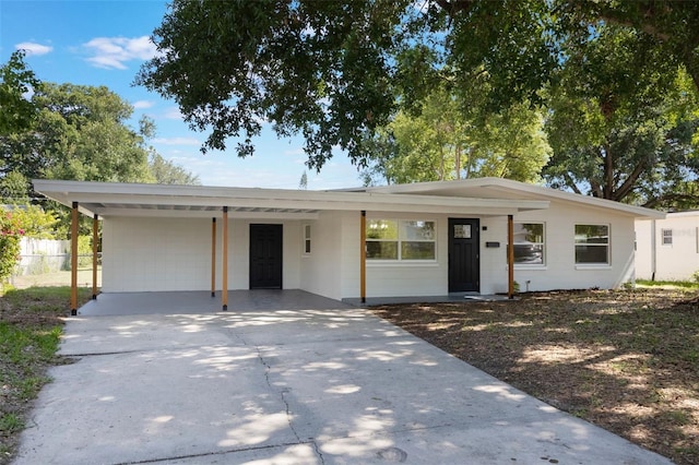 3813 Surrey Dr, Orlando, FL 32812 - ranch-style house with a carport, concrete driveway, and concrete block siding