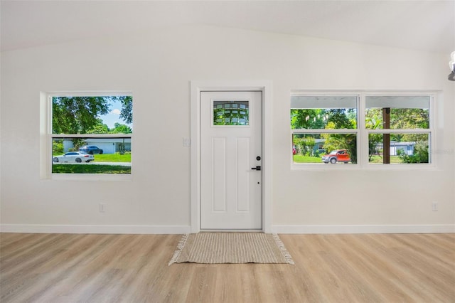 3813 Surrey Dr, Orlando, FL 32812 - entrance foyer with baseboards, wood finished floors, healthy amount of natural light, and vaulted ceiling